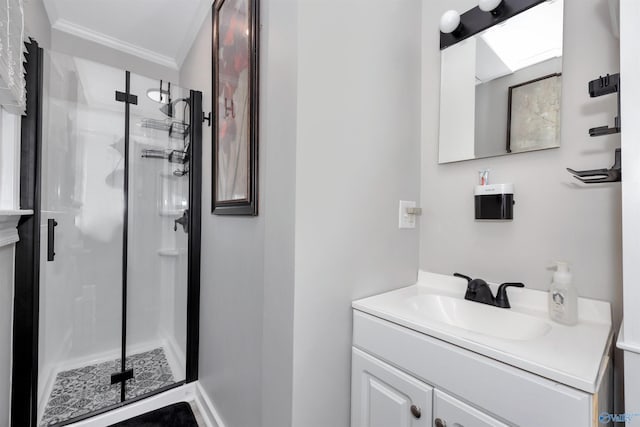 bathroom featuring a shower with door, ornamental molding, and vanity