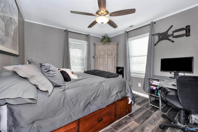 bedroom featuring ceiling fan, ornamental molding, and multiple windows