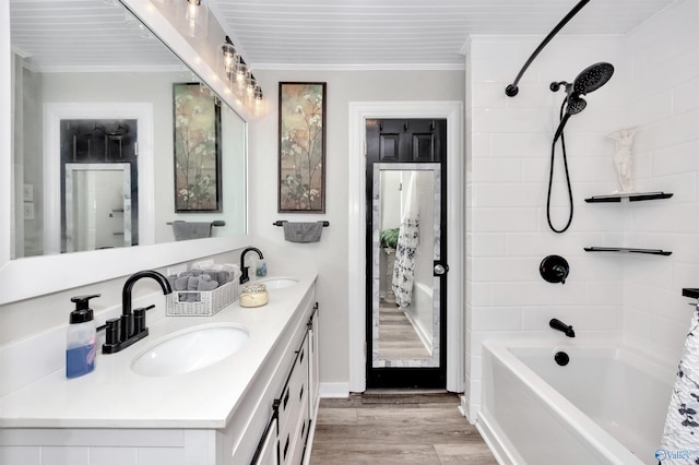 bathroom with vanity, bathtub / shower combination, crown molding, and hardwood / wood-style flooring