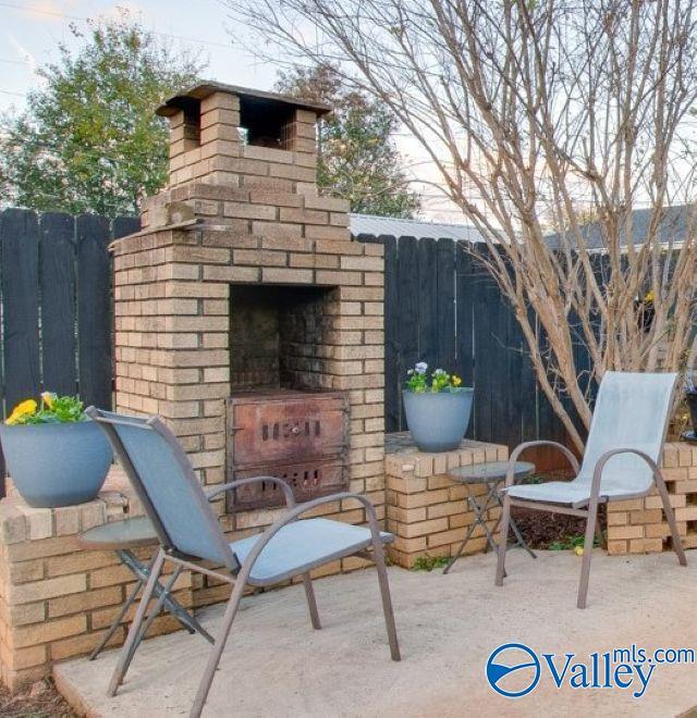 view of patio featuring an outdoor brick fireplace