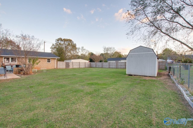 view of yard featuring a storage unit and a patio area