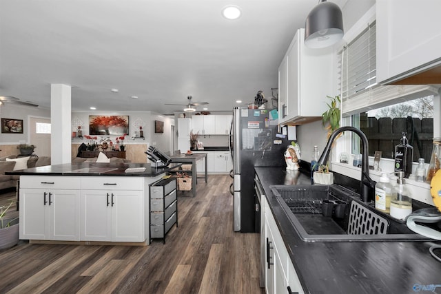 kitchen featuring white cabinets, dark wood-type flooring, sink, stainless steel refrigerator, and ceiling fan