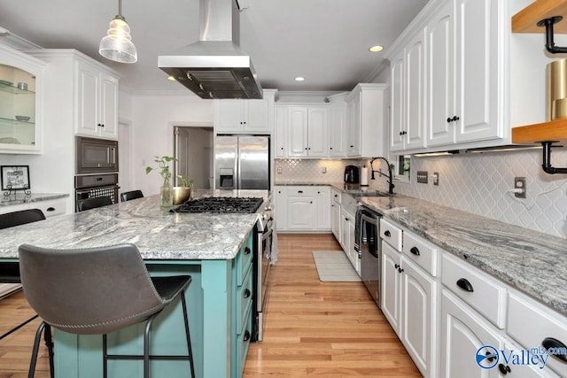 kitchen with black appliances, light wood-type flooring, a kitchen island, white cabinetry, and exhaust hood