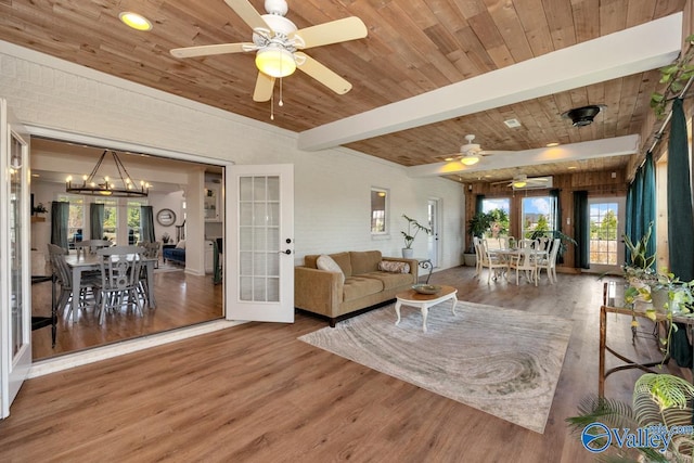 living room featuring dark hardwood / wood-style flooring, beamed ceiling, french doors, and plenty of natural light