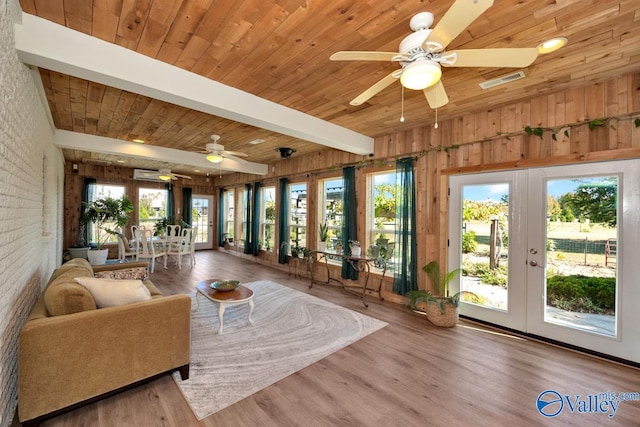 sunroom with french doors, ceiling fan, beamed ceiling, and wooden ceiling