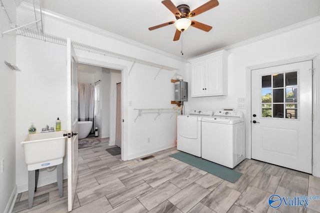 laundry room with washer and clothes dryer, water heater, ornamental molding, cabinets, and ceiling fan