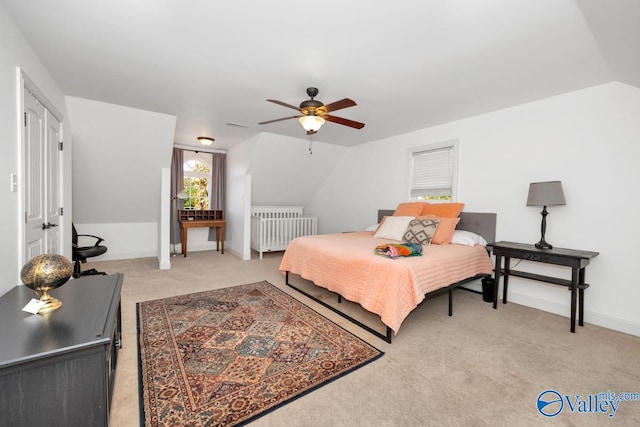 carpeted bedroom featuring lofted ceiling, radiator, and ceiling fan