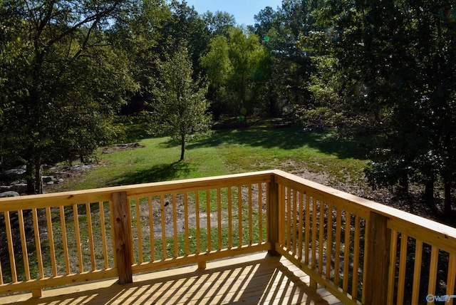 wooden terrace with a lawn