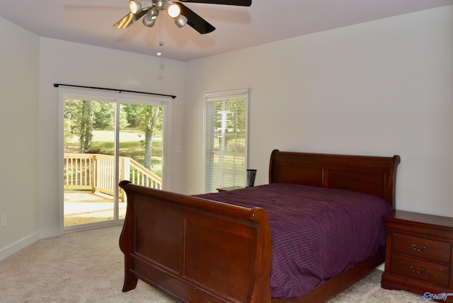 carpeted bedroom featuring access to exterior and ceiling fan