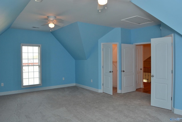 additional living space with ceiling fan, light colored carpet, and lofted ceiling