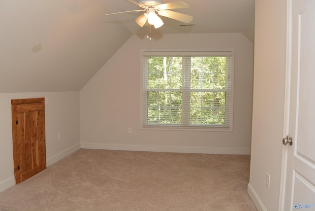 additional living space with lofted ceiling, ceiling fan, and light carpet