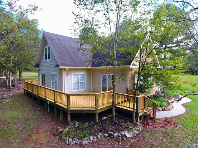 rear view of property featuring a wooden deck