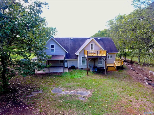 back of property with a yard, a deck, and a patio area