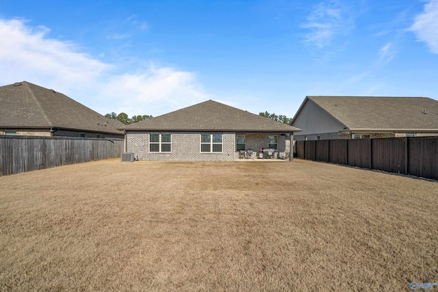 rear view of property with central AC