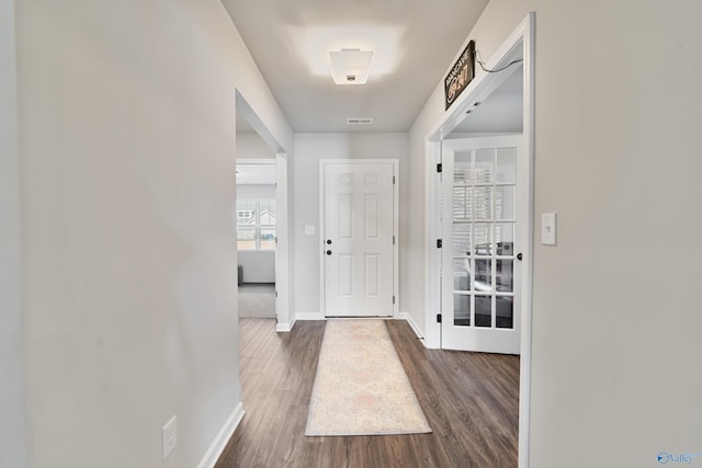 doorway with dark wood-type flooring