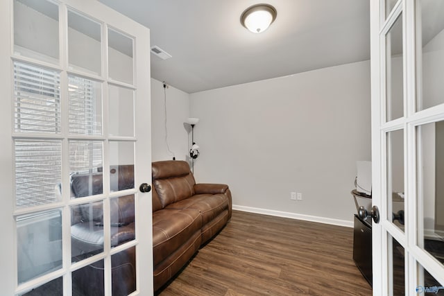 sitting room featuring dark hardwood / wood-style flooring and french doors