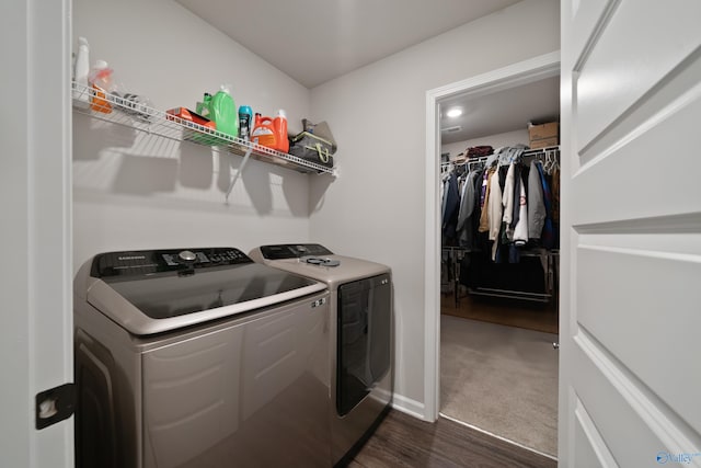 laundry area with washing machine and dryer and dark hardwood / wood-style flooring