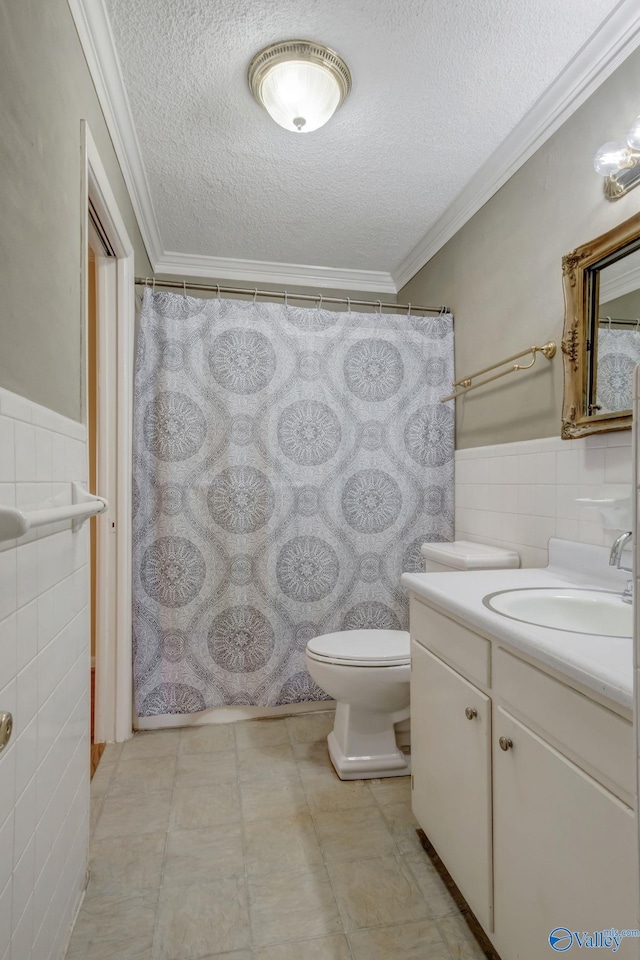 222 Lakewood Dr, Scottsboro, AL 35769 - bathroom with ornamental molding, vanity, a textured ceiling, and tile walls
