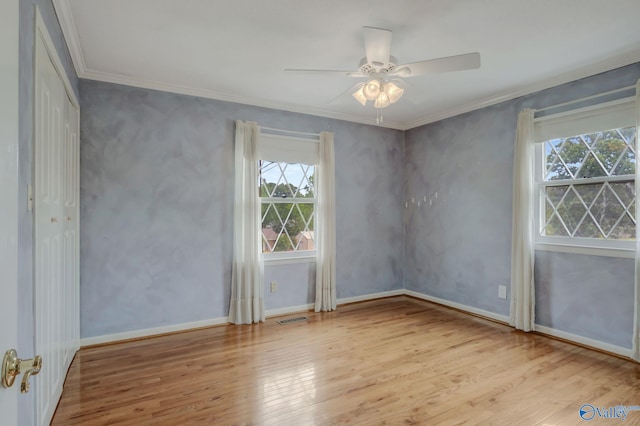 222 Lakewood Dr, Scottsboro, AL 35769 - empty room featuring visible vents, wood finished floors, a wealth of natural light, and crown molding