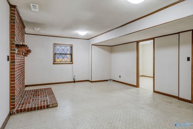 222 Lakewood Dr, Scottsboro, AL 35769 - finished basement featuring baseboards, visible vents, a textured ceiling, and ornamental molding