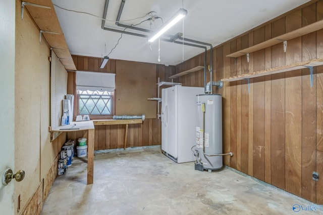 222 Lakewood Dr, Scottsboro, AL 35769 - below grade area with water heater, wood walls, and white refrigerator with ice dispenser