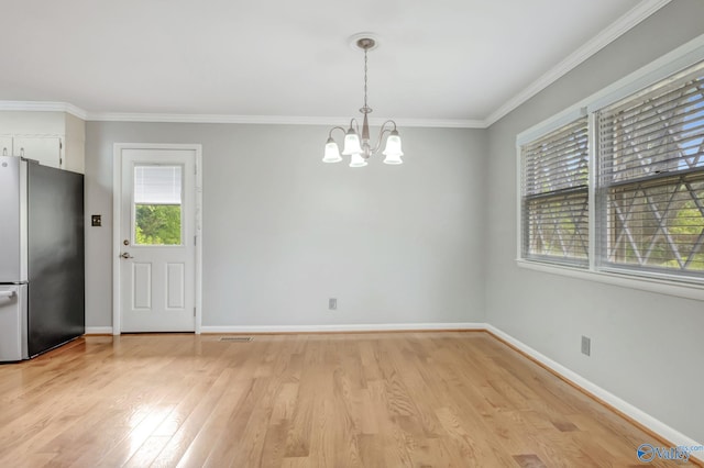 222 Lakewood Dr, Scottsboro, AL 35769 - unfurnished dining area with light wood-style flooring, visible vents, baseboards, an inviting chandelier, and crown molding