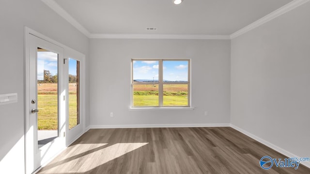 unfurnished living room featuring ornamental molding, a wealth of natural light, and dark wood-type flooring