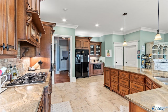 24051 Piney Creek Dr, Athens, AL 35613 - kitchen featuring crown molding, black fridge, backsplash, and brown cabinetry