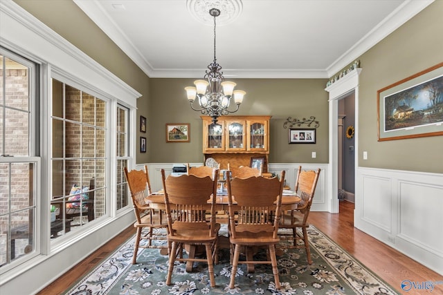 24051 Piney Creek Dr, Athens, AL 35613 - dining space featuring ornamental molding, wood finished floors, a notable chandelier, and a wainscoted wall