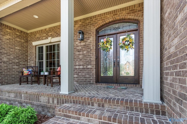 24051 Piney Creek Dr, Athens, AL 35613 - entrance to property featuring covered porch, brick siding, and french doors