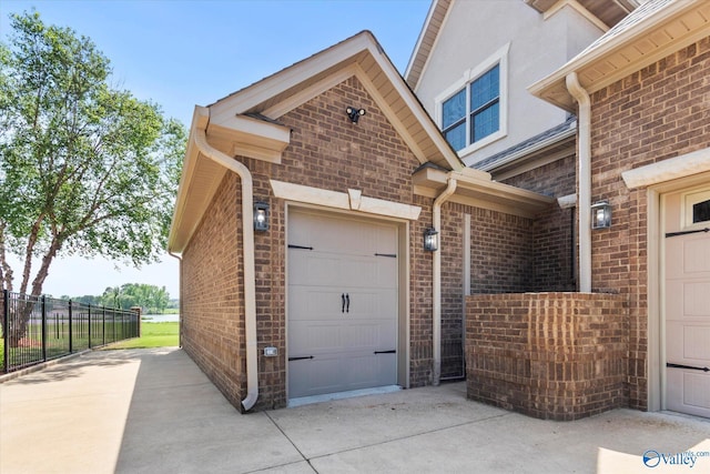 24051 Piney Creek Dr, Athens, AL 35613 - view of side of property with fence, an attached garage, brick siding, stucco siding, and concrete driveway