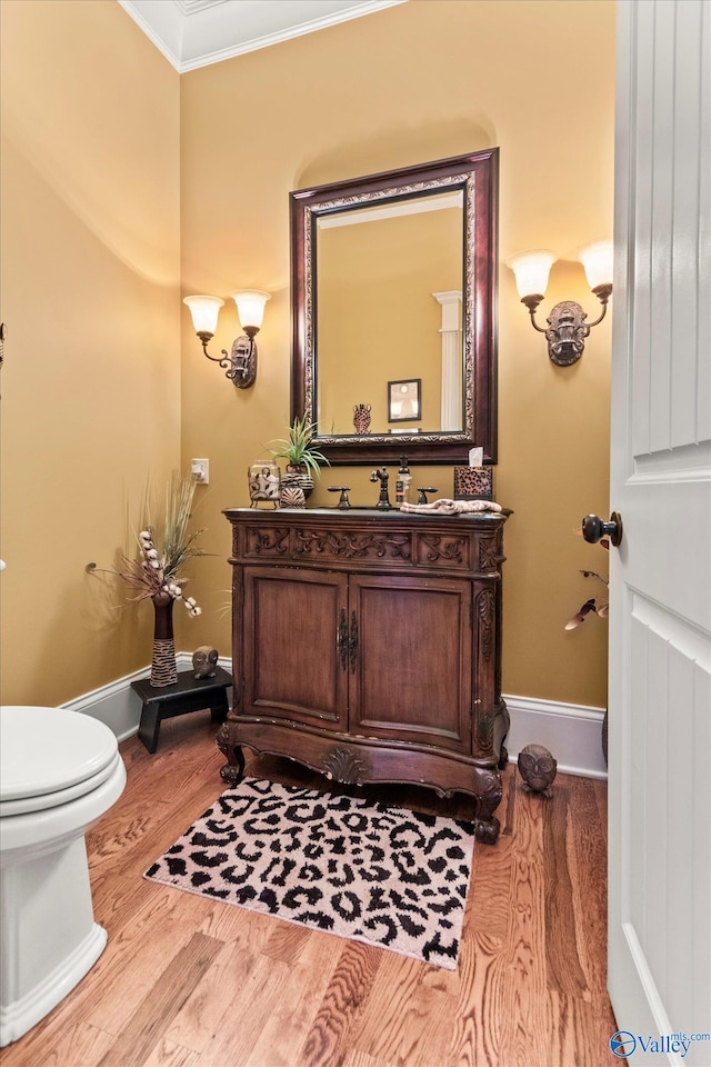 24051 Piney Creek Dr, Athens, AL 35613 - half bath featuring vanity, crown molding, wood finished floors, toilet, and baseboards