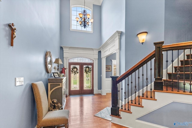 24051 Piney Creek Dr, Athens, AL 35613 - foyer entrance featuring a chandelier, stairs, wood finished floors, and a towering ceiling