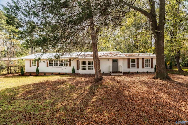 ranch-style house with a front lawn