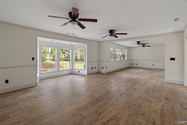 unfurnished living room with ceiling fan, a healthy amount of sunlight, light hardwood / wood-style flooring, and ornamental molding