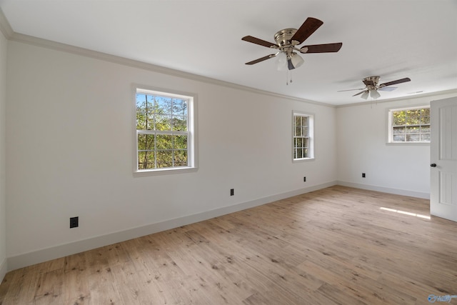 spare room featuring ceiling fan, light hardwood / wood-style floors, crown molding, and plenty of natural light