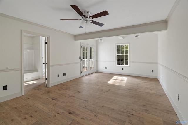 empty room with ornamental molding, french doors, light hardwood / wood-style flooring, and ceiling fan