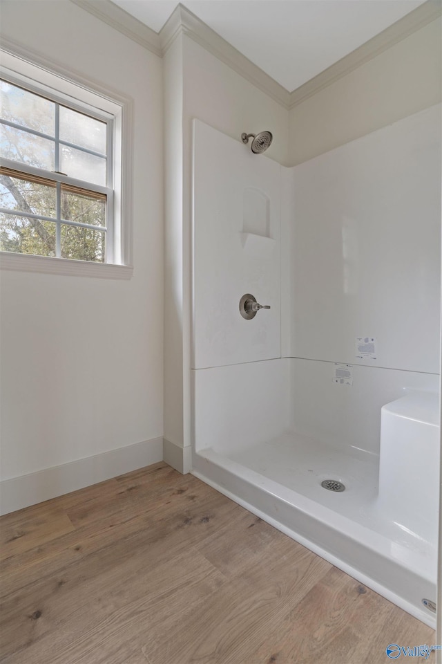 bathroom with walk in shower, hardwood / wood-style floors, and crown molding