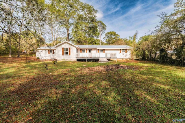 back of property with a lawn and a deck