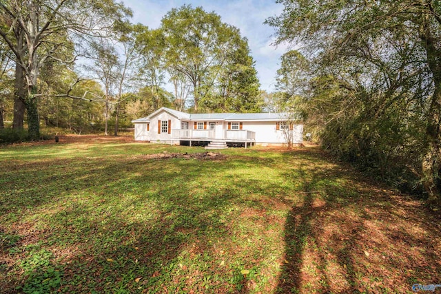 exterior space featuring a lawn and a wooden deck