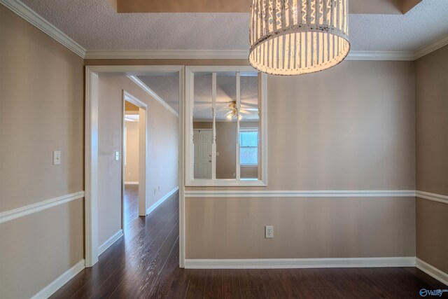 unfurnished dining area featuring crown molding, a textured ceiling, dark hardwood / wood-style floors, and ceiling fan