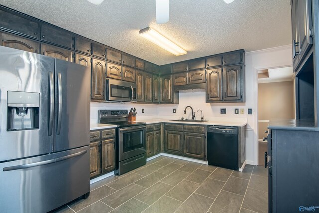 kitchen with sink, appliances with stainless steel finishes, dark brown cabinetry, and a textured ceiling