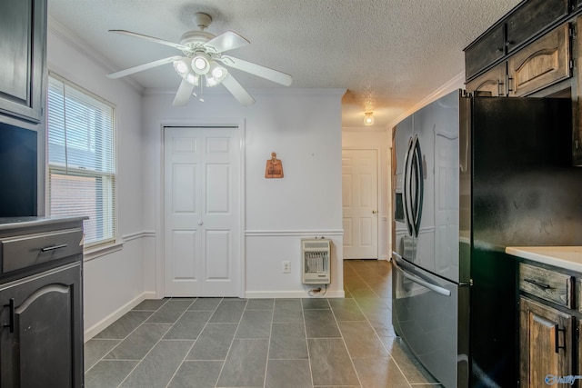 kitchen featuring heating unit, ceiling fan, stainless steel fridge with ice dispenser, dark tile patterned flooring, and crown molding