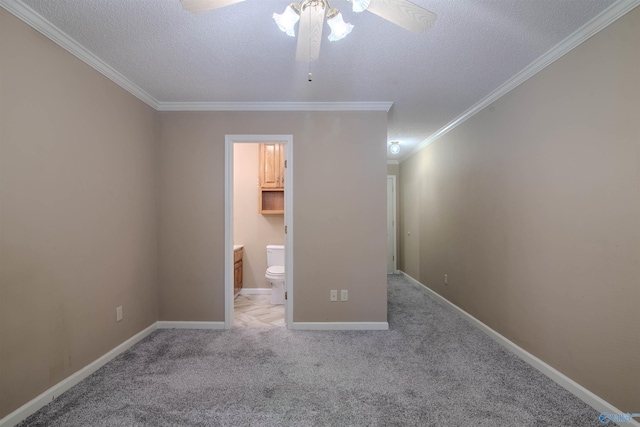 interior space featuring a spacious closet, a textured ceiling, ceiling fan, light carpet, and crown molding