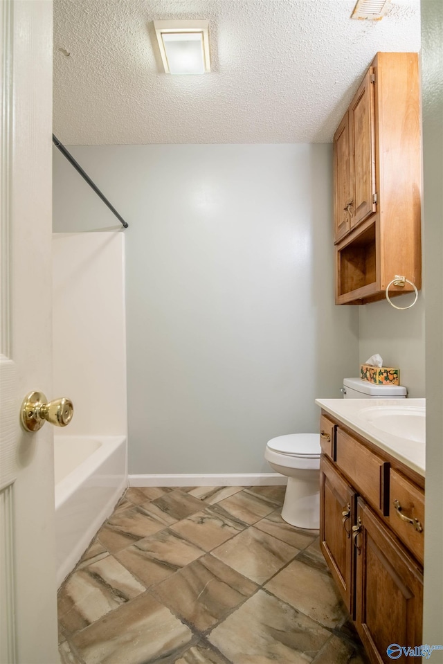 full bathroom with  shower combination, vanity, a textured ceiling, and toilet