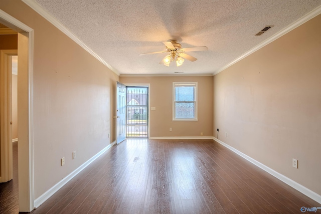 spare room with crown molding, a textured ceiling, and dark wood-type flooring