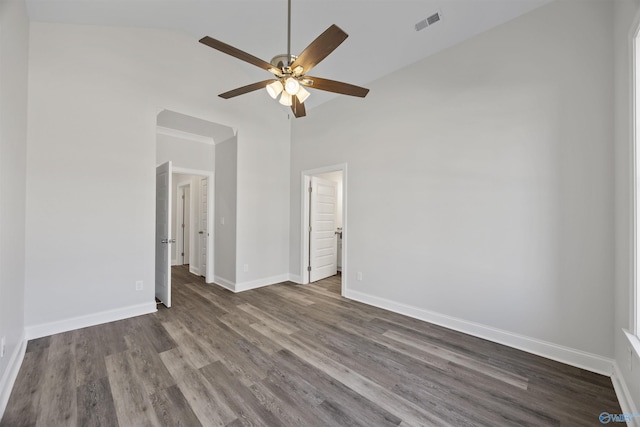 spare room with visible vents, ceiling fan, wood finished floors, high vaulted ceiling, and baseboards