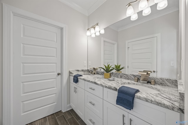 bathroom with double vanity, ornamental molding, a sink, and wood finish floors