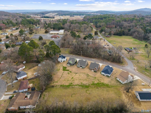 aerial view featuring a forest view and a mountain view