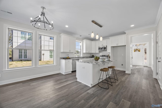 kitchen with white cabinetry, visible vents, appliances with stainless steel finishes, and crown molding